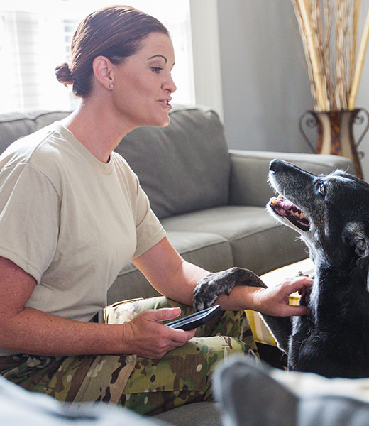 A military service member and her dog enjoying their home